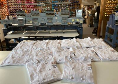 Tuscan Kitchen chefs Embordered vests in production